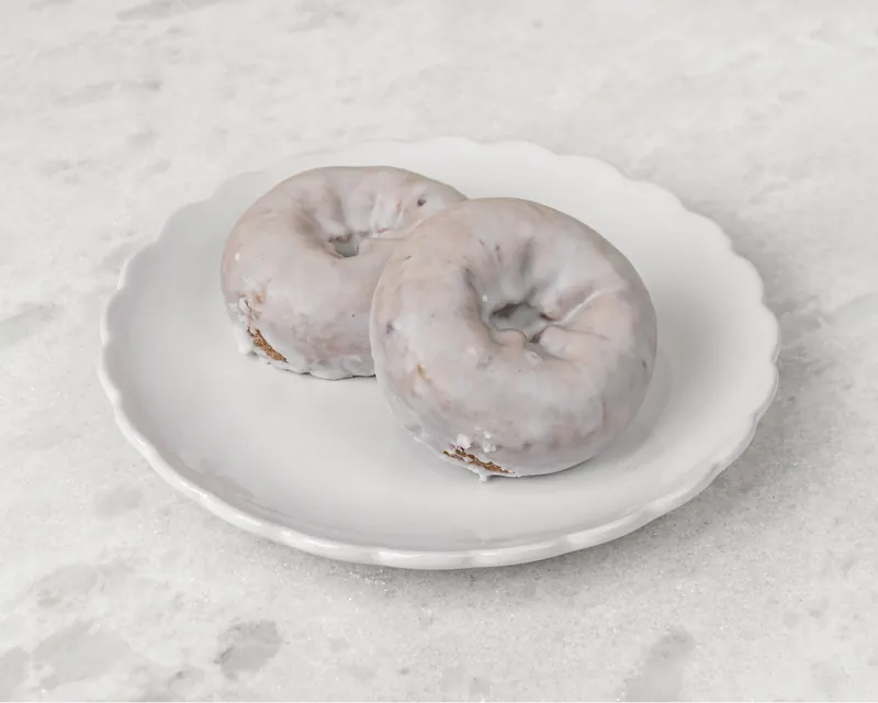 Two glazed blueberry cake donuts