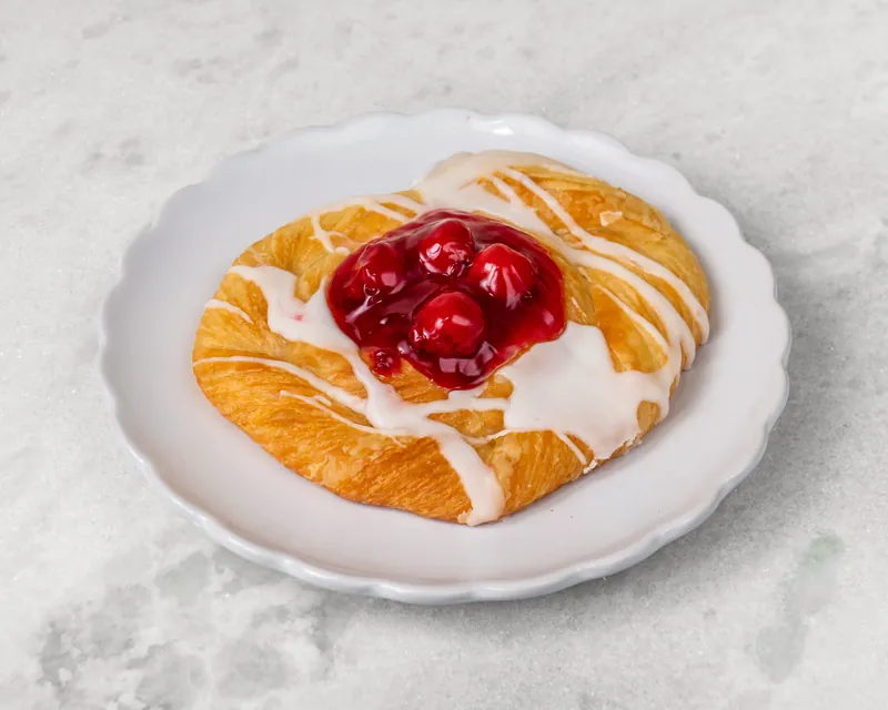 Cherry danish with icing drizzle