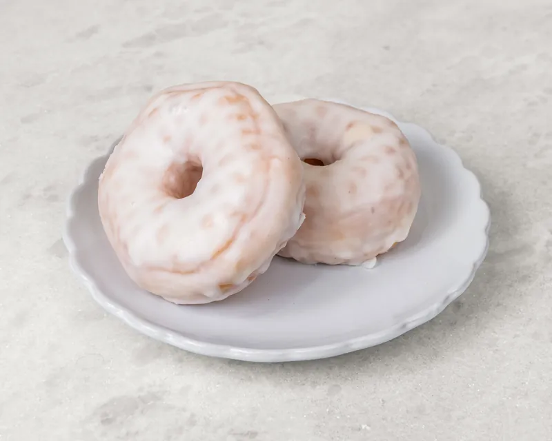 Two classic glazed ring donuts