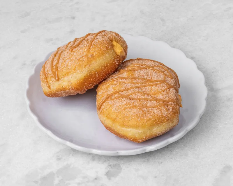 Two pumpkin cream cheese donuts