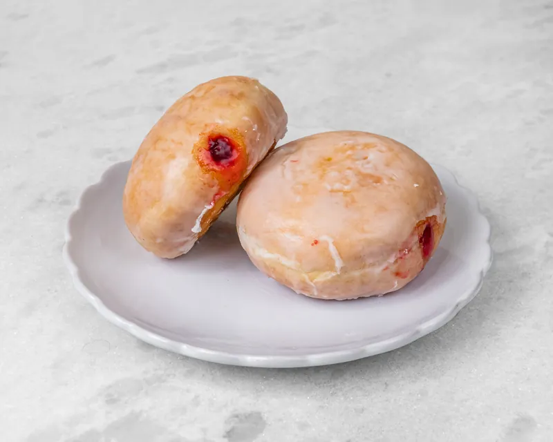 Glazed raspberry jelly filled donuts