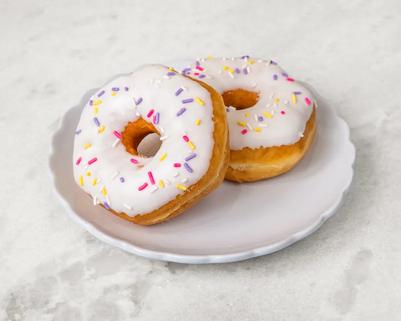 Vanilla-iced donuts with rainbow sprinkles