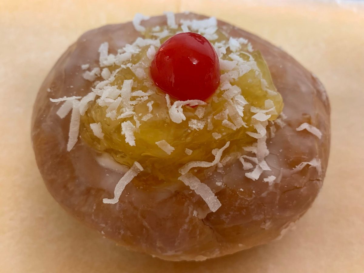 Coconut and cherry topped specialty donut