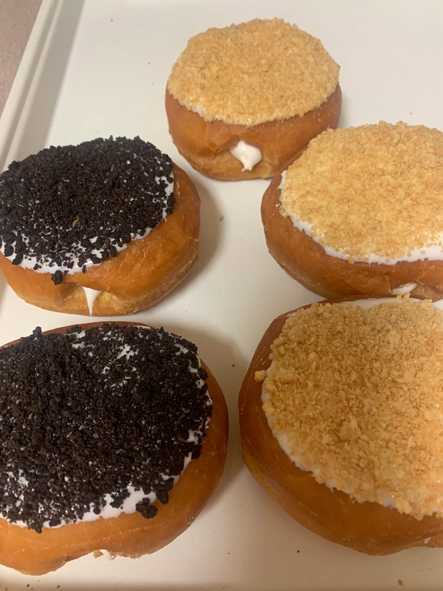 Cream-filled donuts topped with cookie crumbs and graham