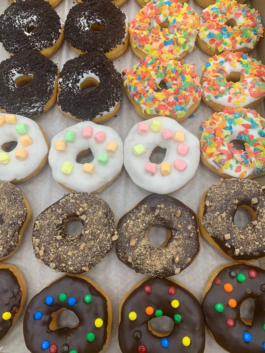 Tray of specialty Crossroads donuts topped with Oreo, Fruity Pebbles, marshmallow and toffee