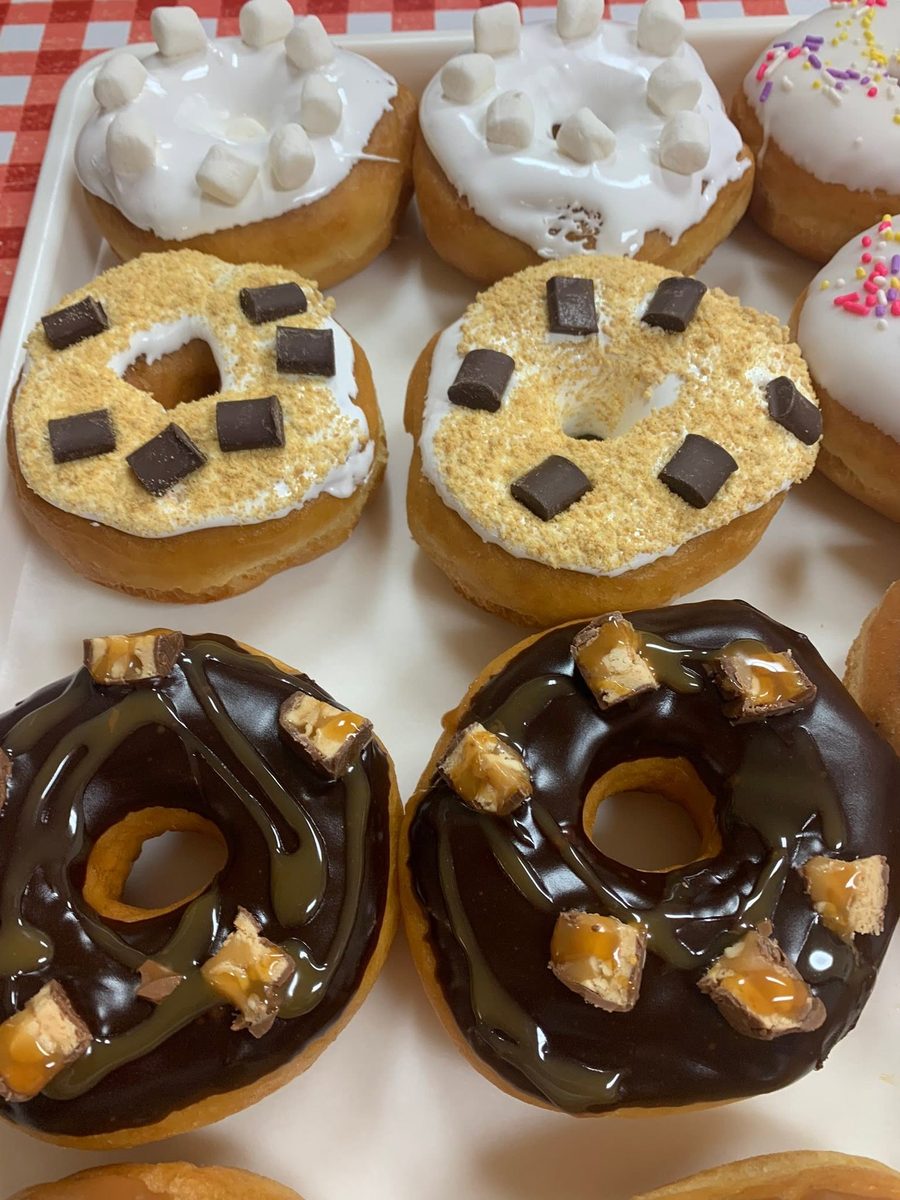 S'mores and Snickers gourmet donuts on a checkered tray